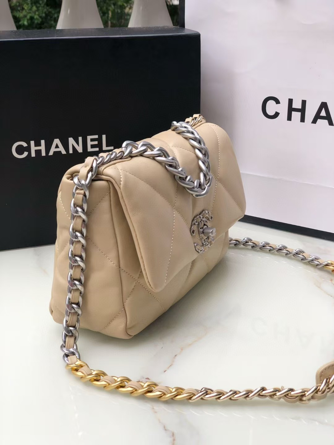 Ch*el 19 handbag shiny leather, gold-tone, silver-tone & ruthenium-finish metal beige 26x16x9cm