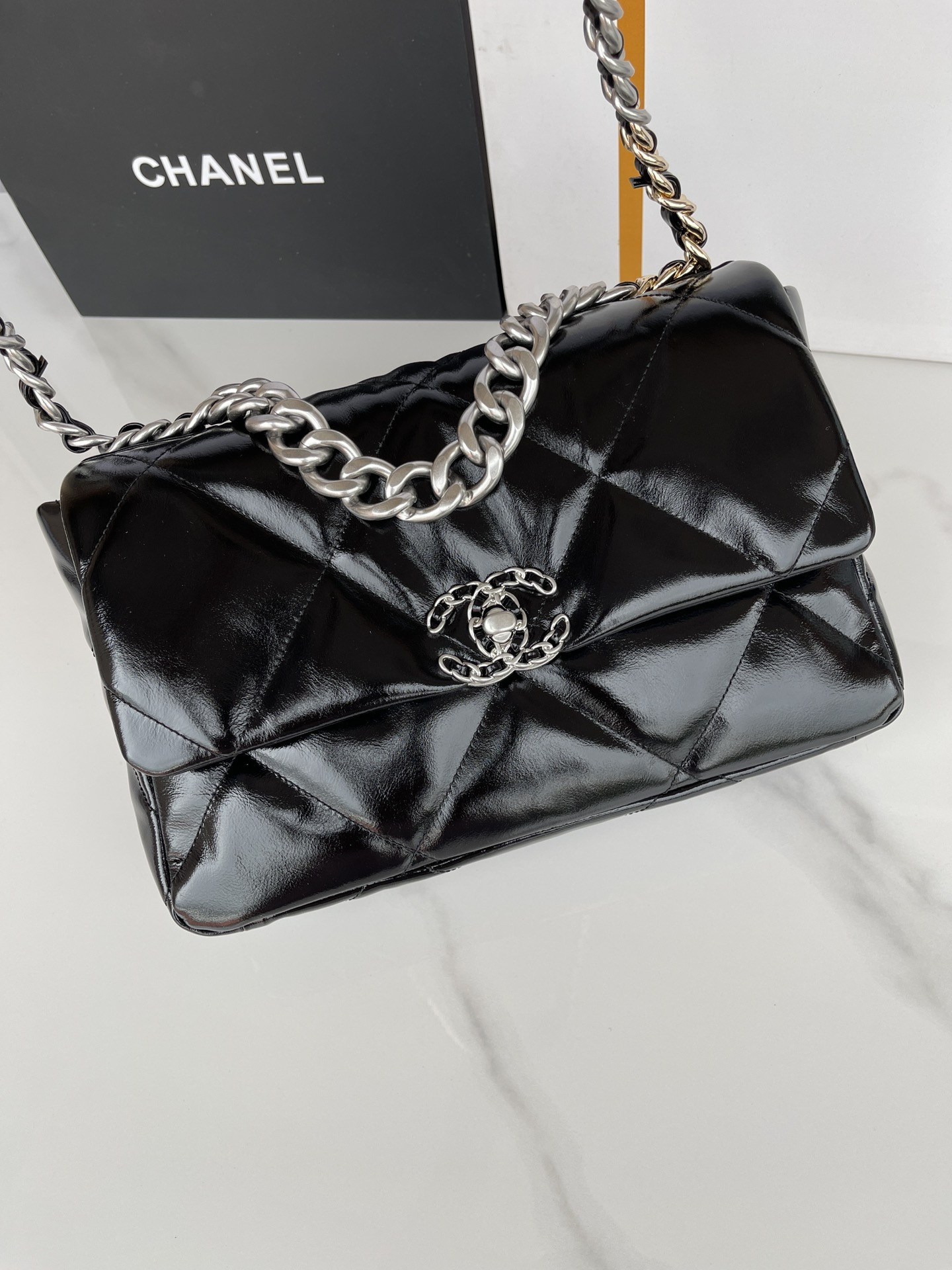 Ch*el 19 large handbag shiny leather, gold-tone, silver-tone & ruthenium-finish metal black 7.8 × 11.7 × 3.9 in